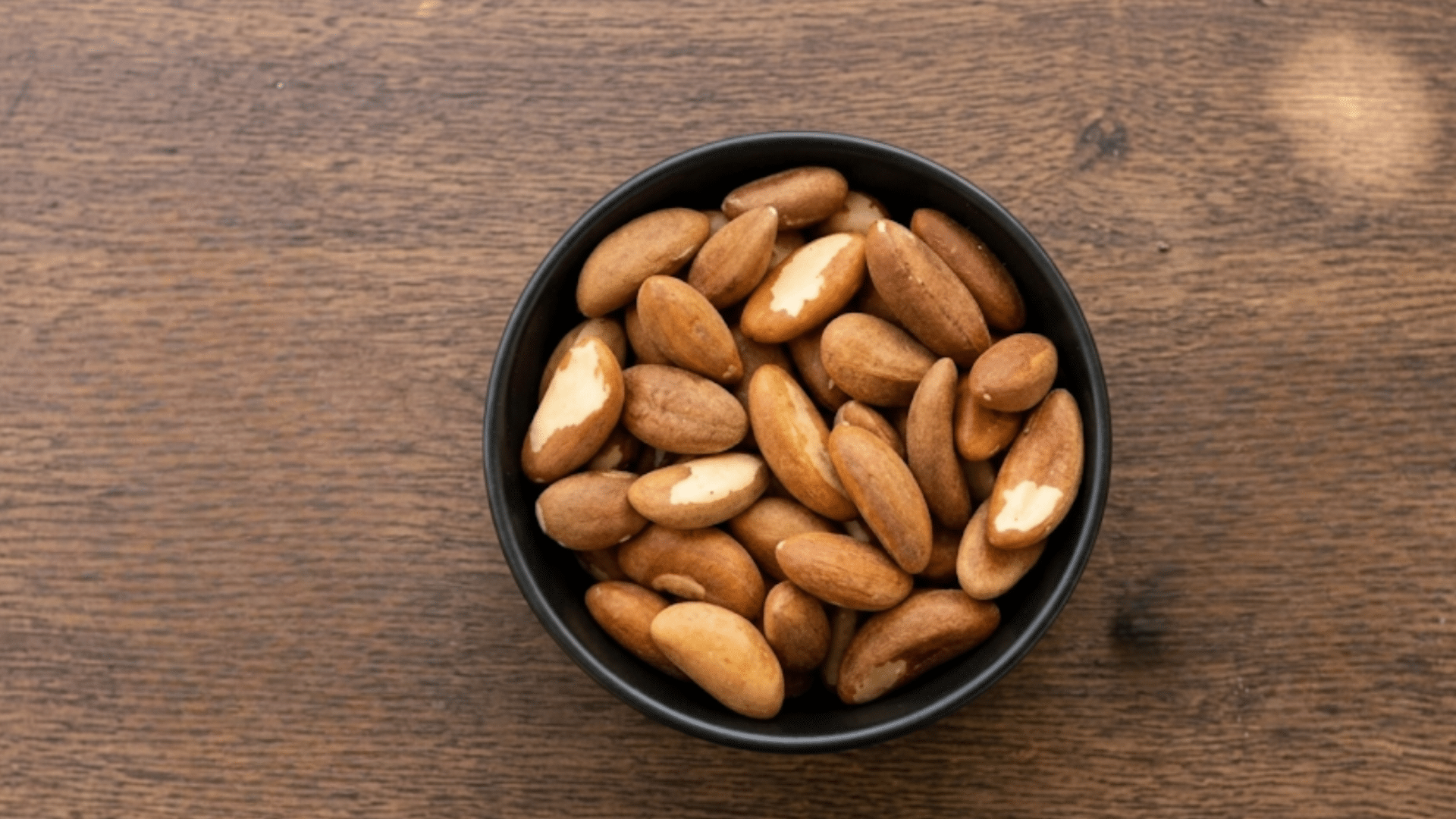 bowl of brazil nuts showing a nutrient dense snack that is rich in selenium and healthy fat