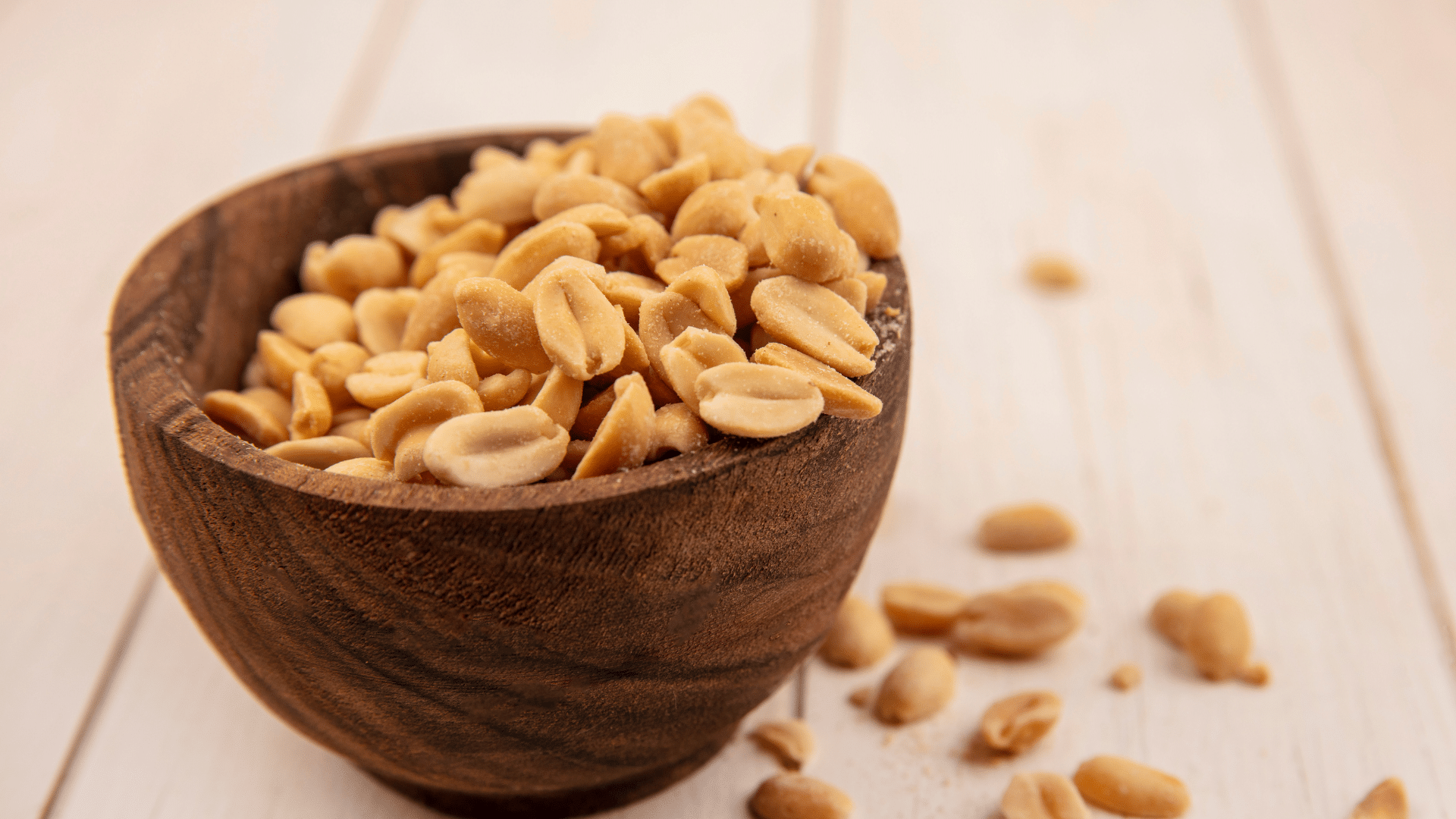 bowl of roasted peanuts showing a protein rich snack that fits into a balanced eating plan