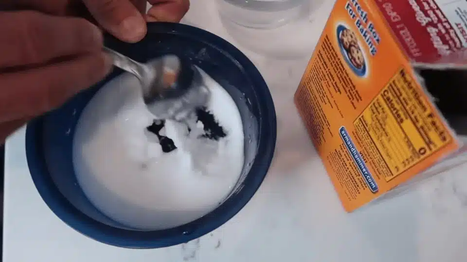 a person with a soft sponge scrubbing inside of the pan (1)