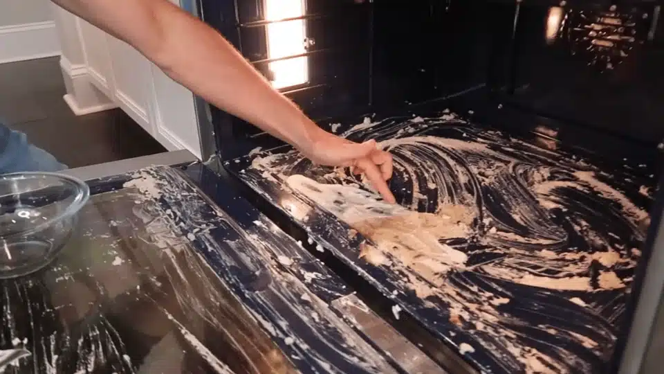 a person with a soft sponge scrubbing inside of the pan (3)