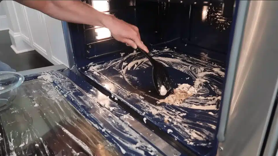 a person with a soft sponge scrubbing inside of the pan (4)