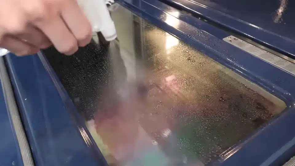 a person with a soft sponge scrubbing inside of the pan (5)