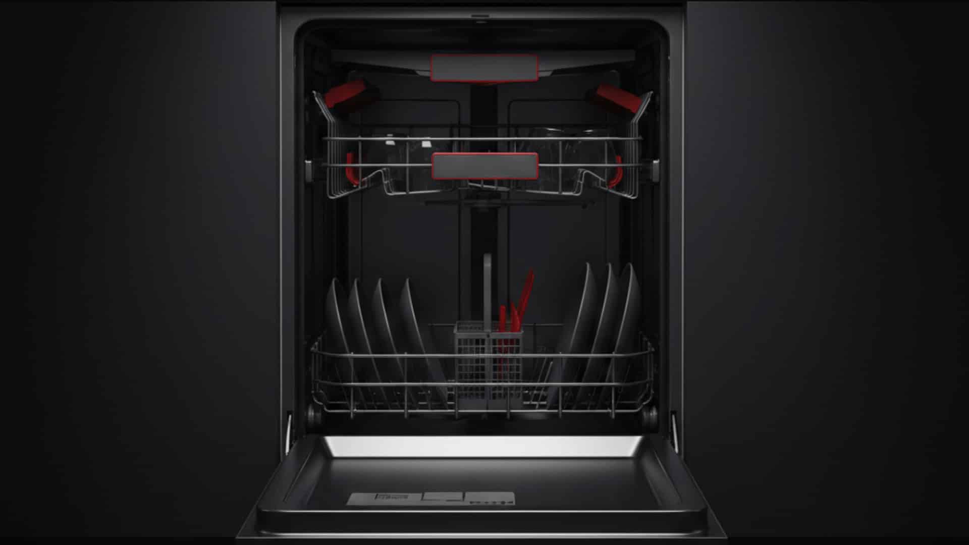 open stainless steel dishwasher in dark kitchen with red interior accents and plates on lower rack