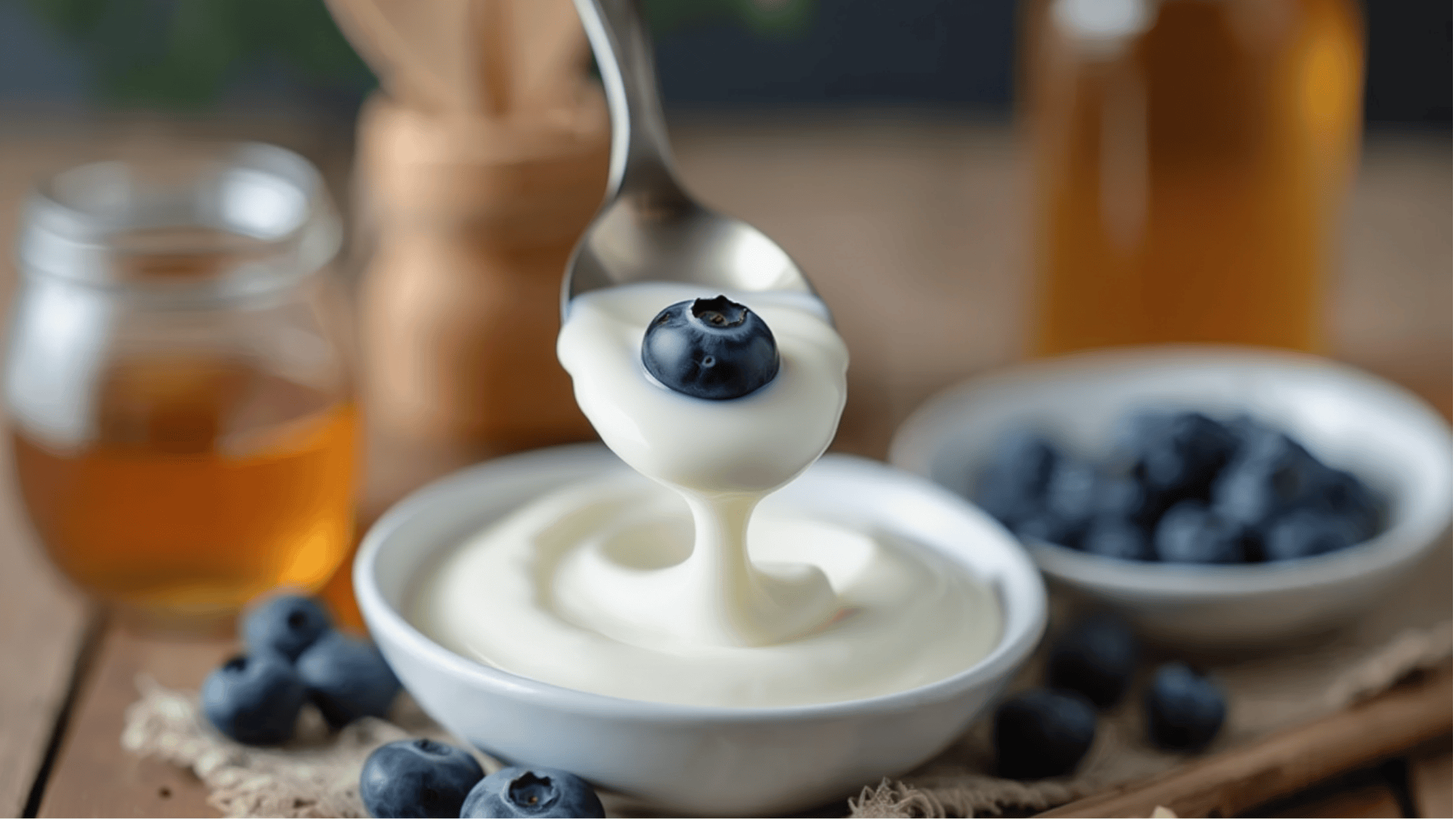 yogurt with a fresh blueberry on top, ready to enjoy as a healthy snack or part of an acid reflux-friendly meal.