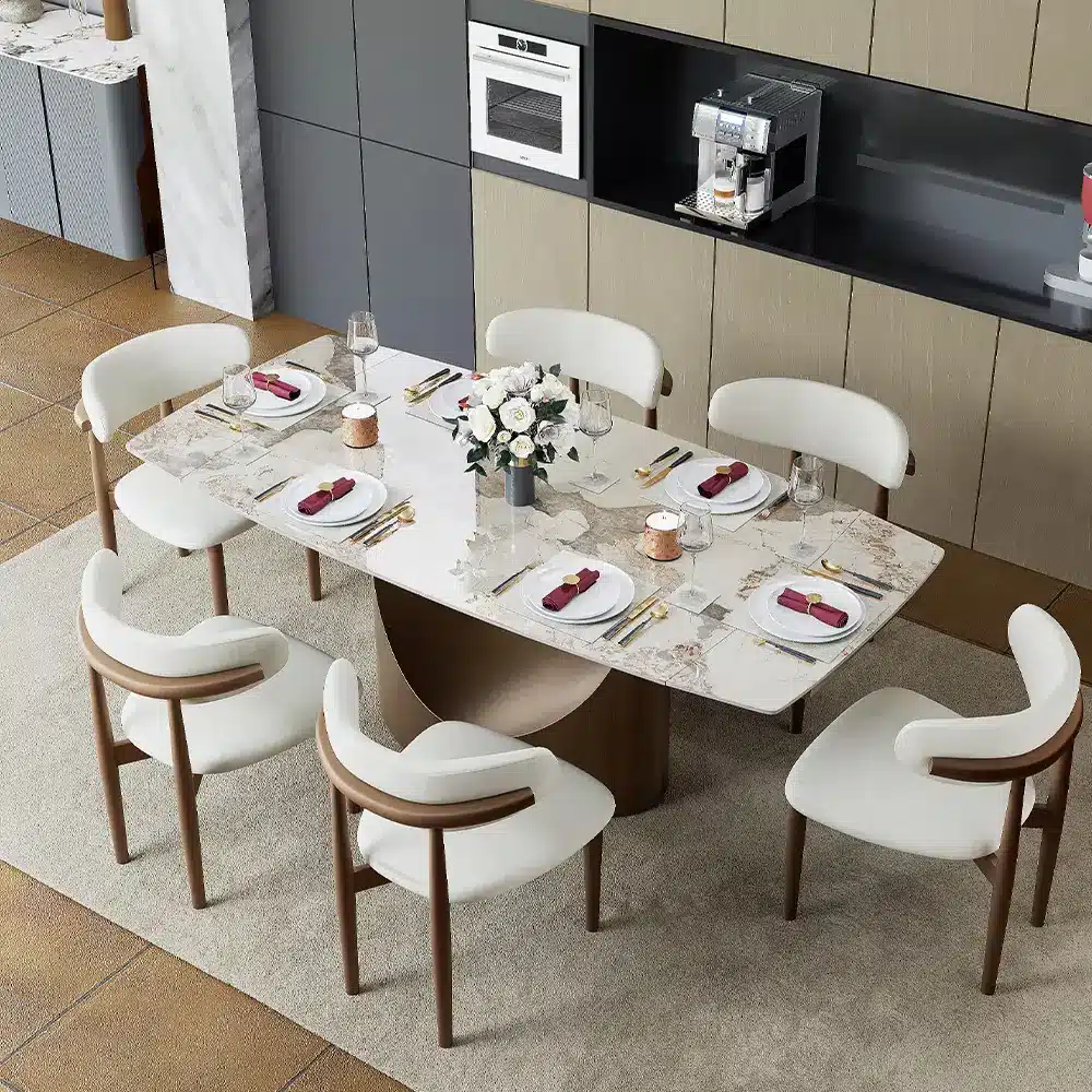 Elegant marble dining table set with six white chairs in modern kitchen setting