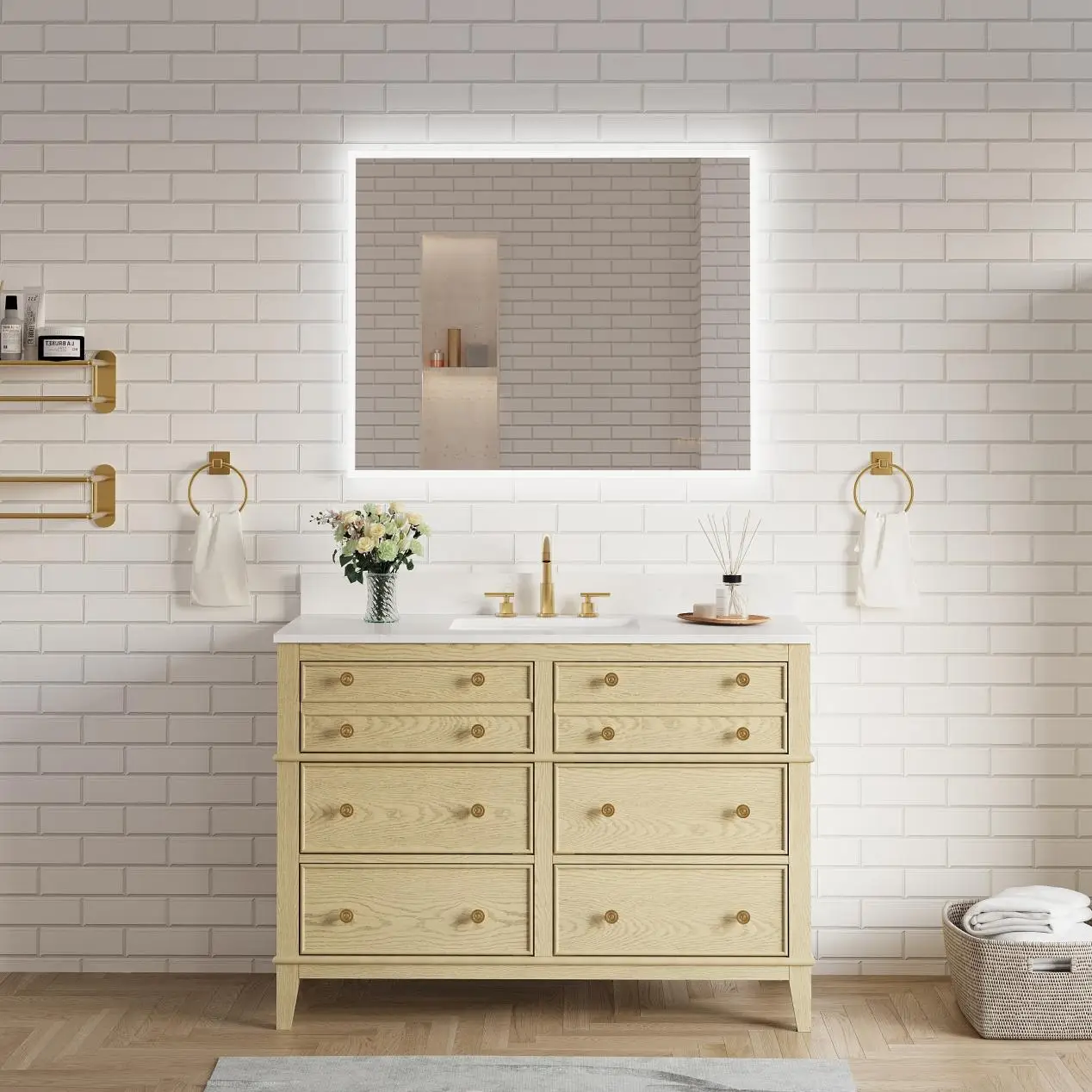 Light wood bathroom vanity with brass fixtures and LED mirror against white subway tile wall
