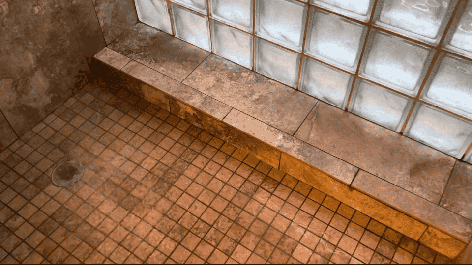 a picture from washroom with the water running down from the shower