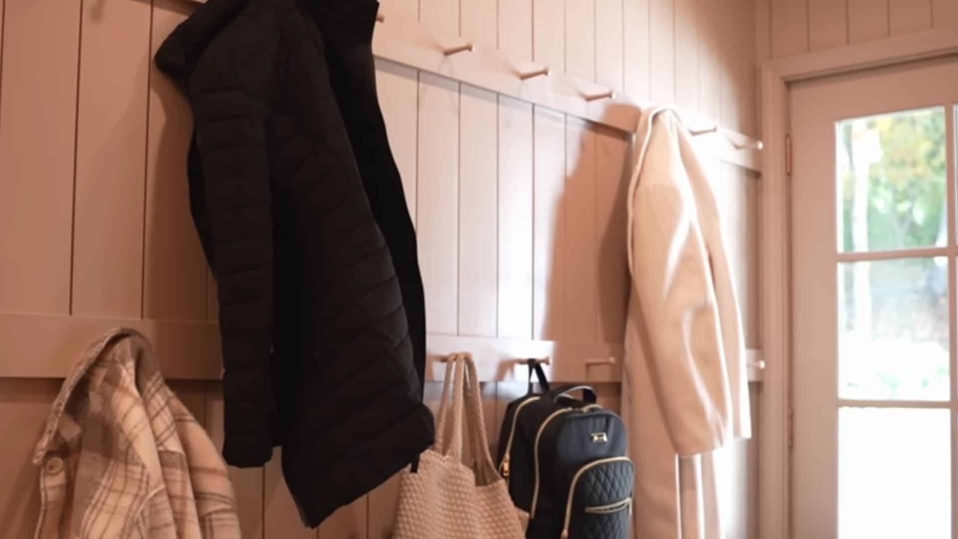 Compact laundry room using wall hooks to save space and keep the floor clear (1)