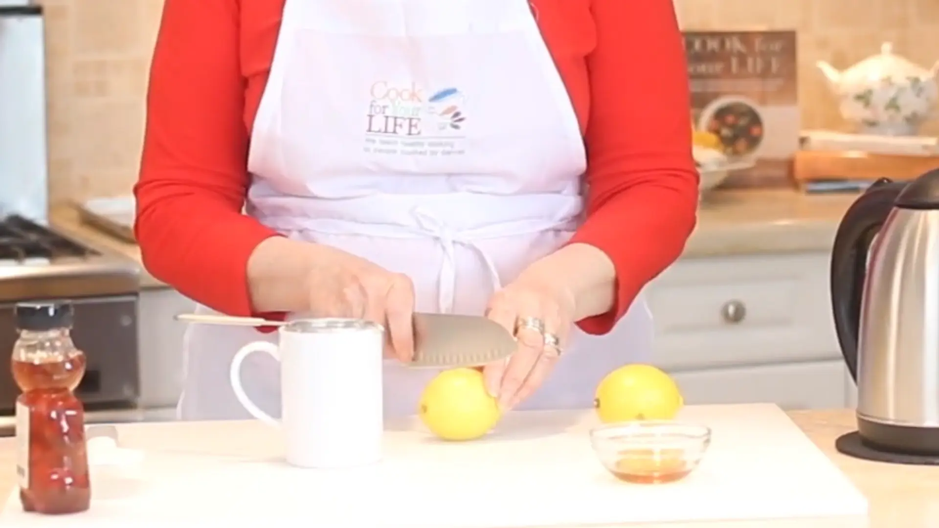 fresh lemon cut into two halves on wooden board for lemon and honey drink preparation