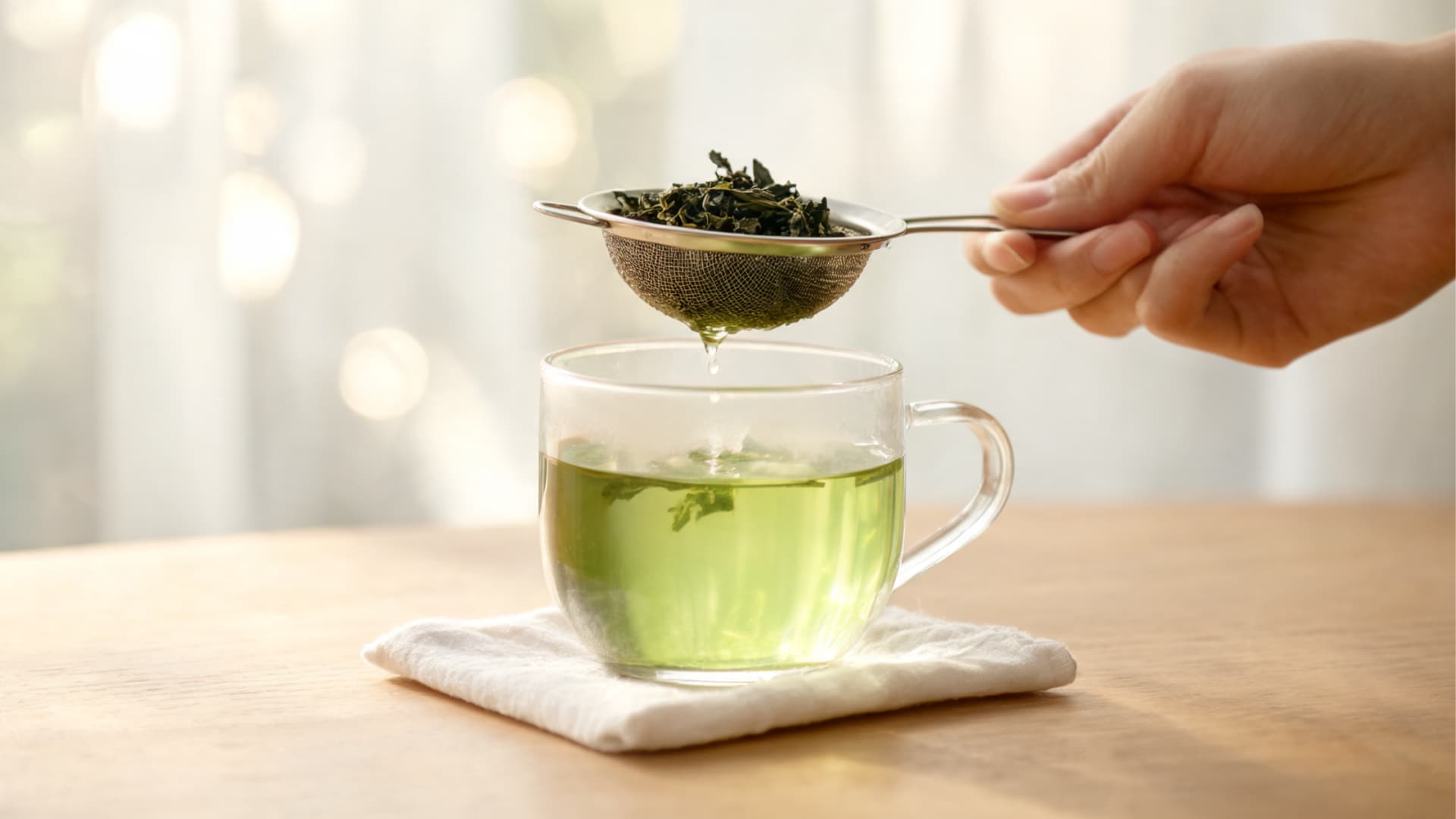 removing tea leaves to stop brewing and serve fresh smooth green tea ready to drink