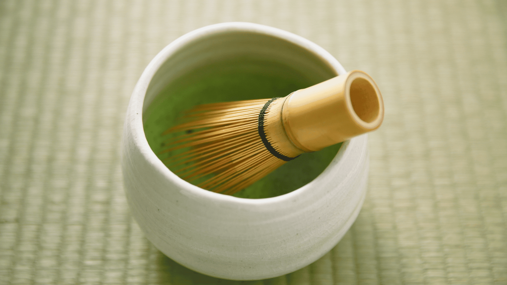 bamboo whisk and matcha bowl used in a matcha latte recipe