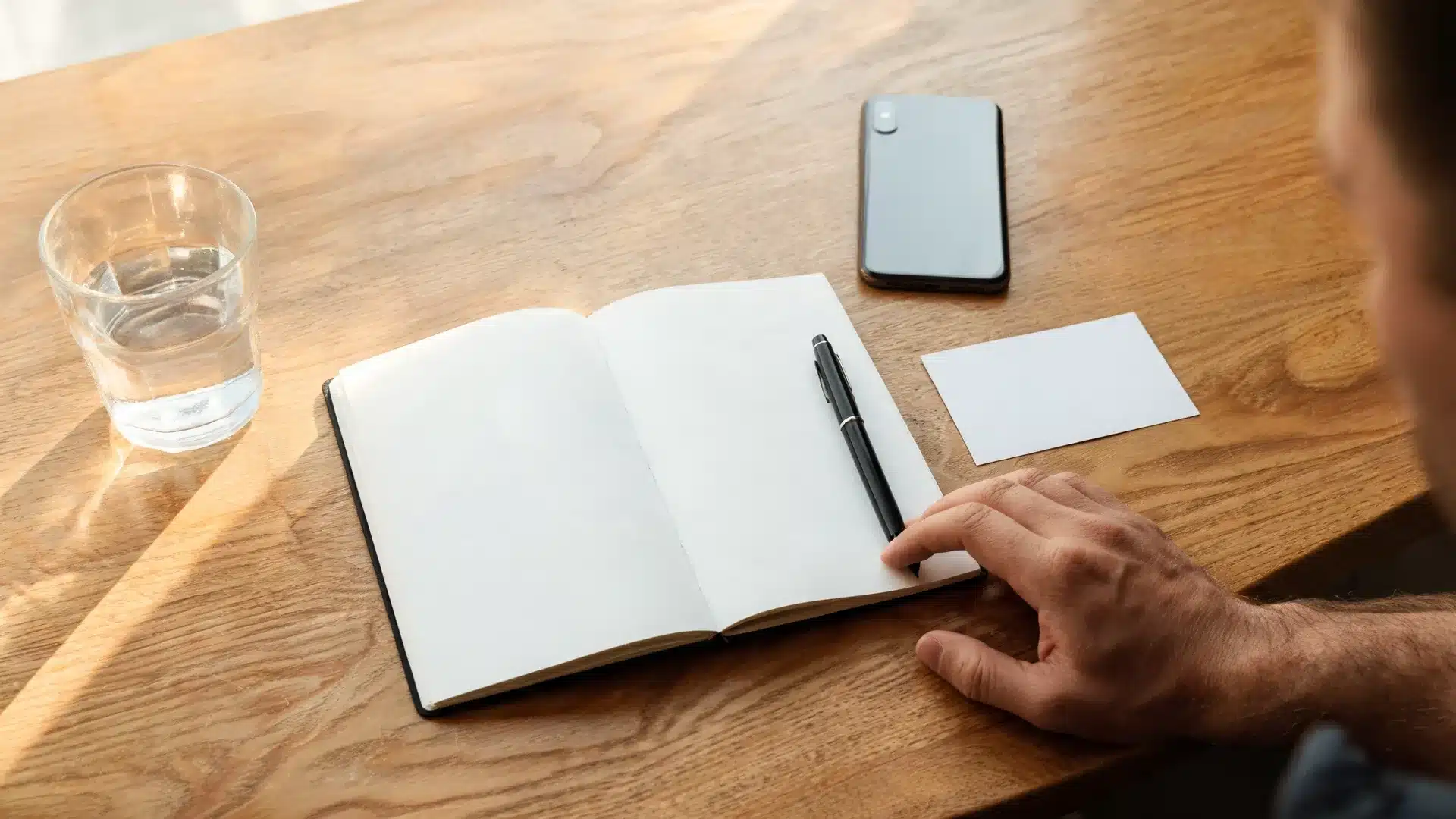 blank notebook and pen showing how to write daily affirmations for men in a simple morning routine