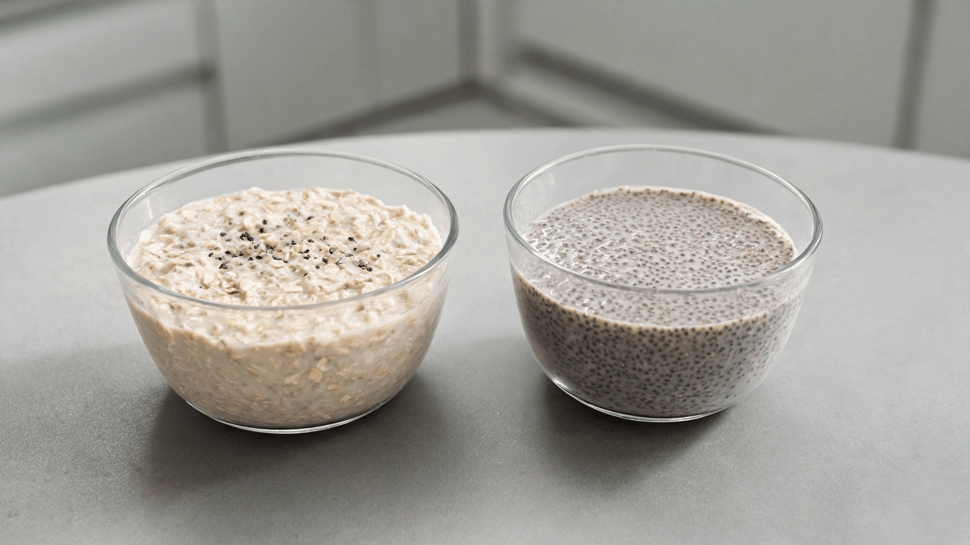 Bowls of creamy overnight oats and chia seed pudding served on a gray kitchen counter