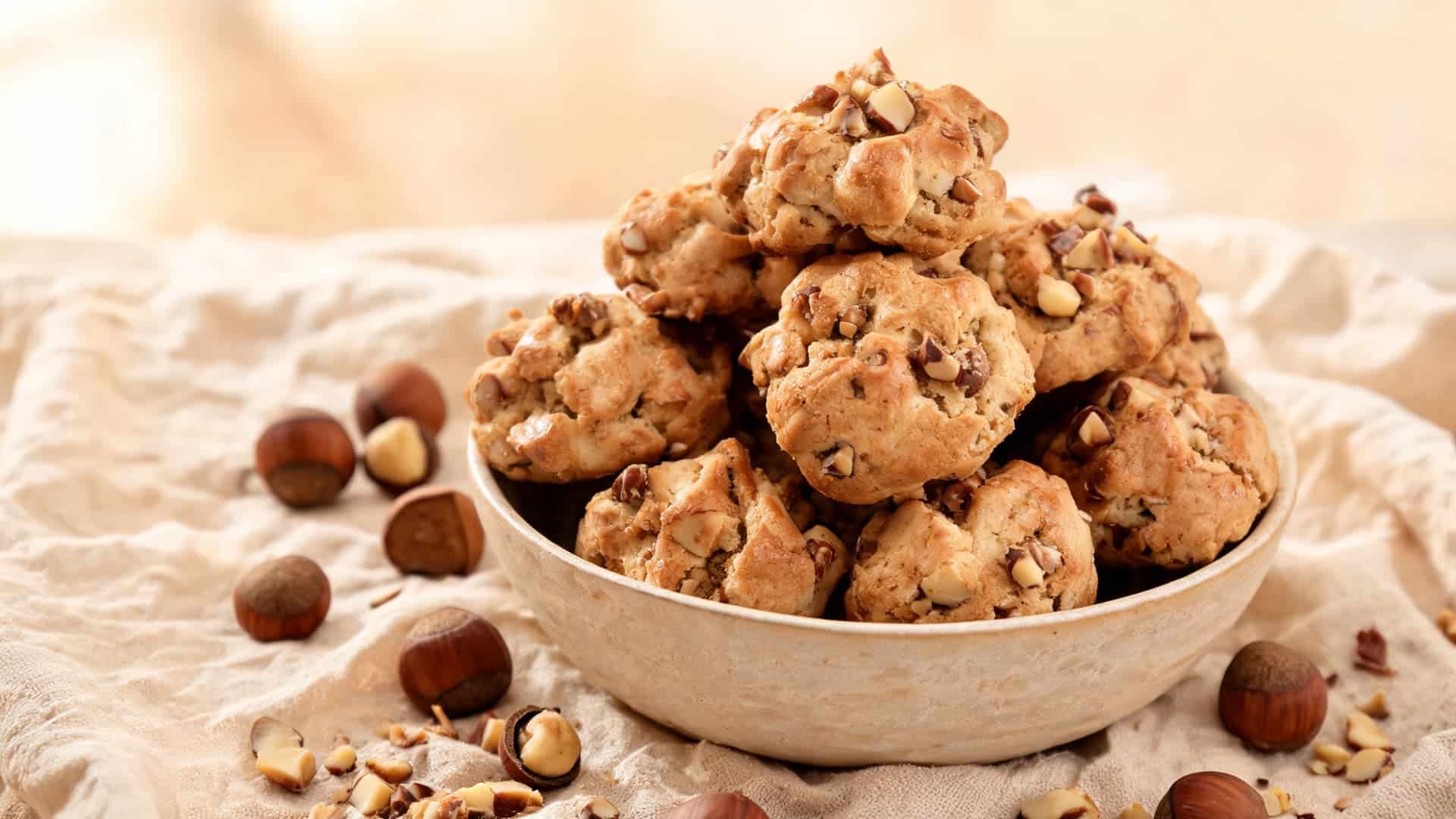 brutti ma buoni hazelnut meringue cookies irregular rustic shapes golden baked texture soft bakery cloth setting