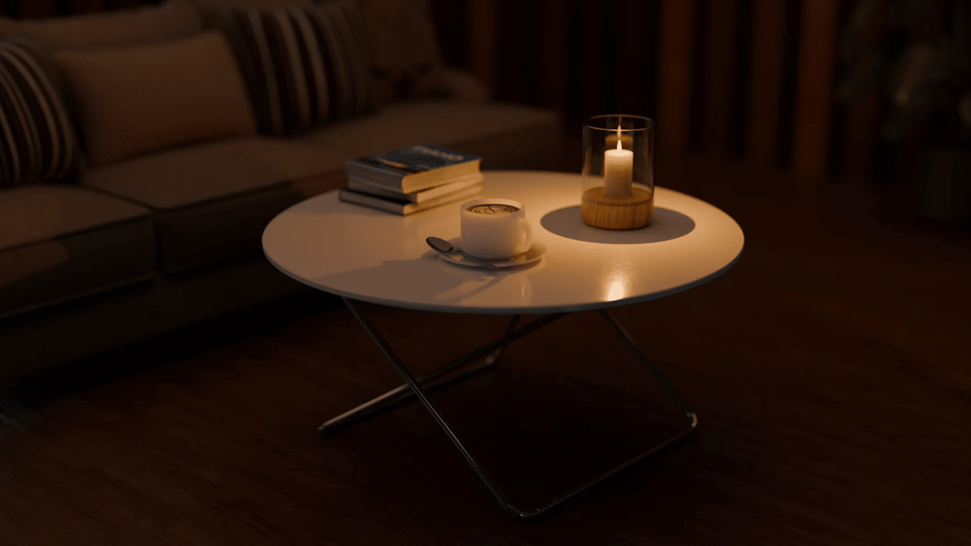 coffee cup and lit candle on a round coffee table with stacked books creating a warm cozy evening setting