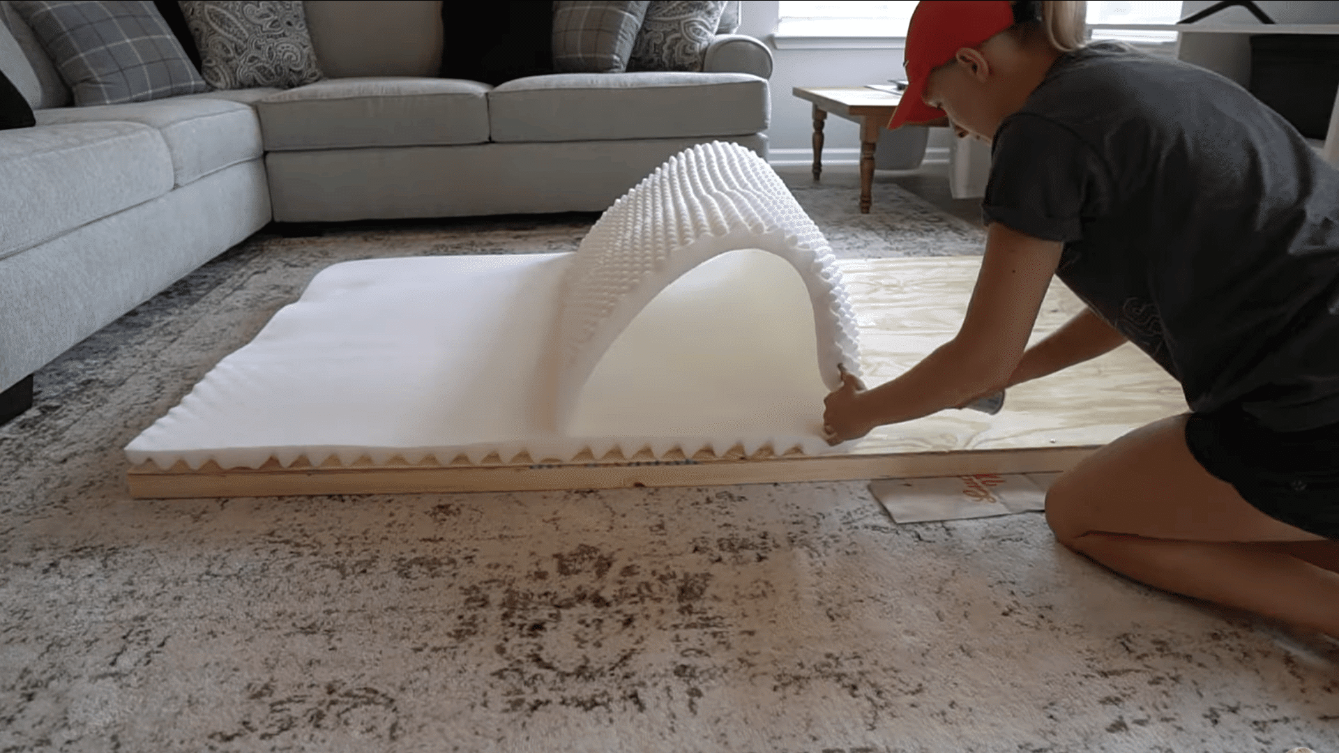 foam padding placed on the plywood surface for a soft upholstered headboard layer
