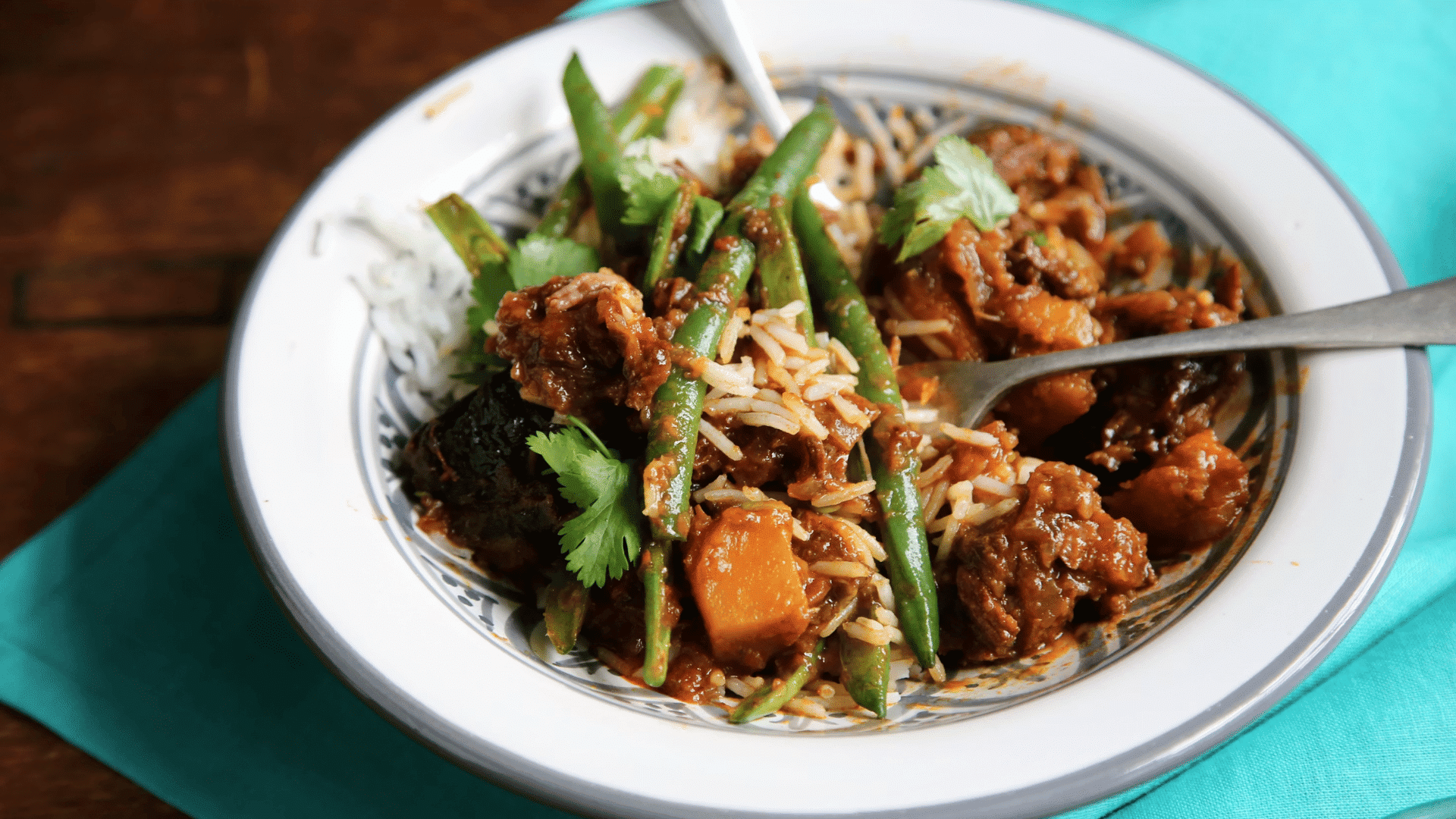 rice dish with vegetables green beans and savory curry served on a plate
