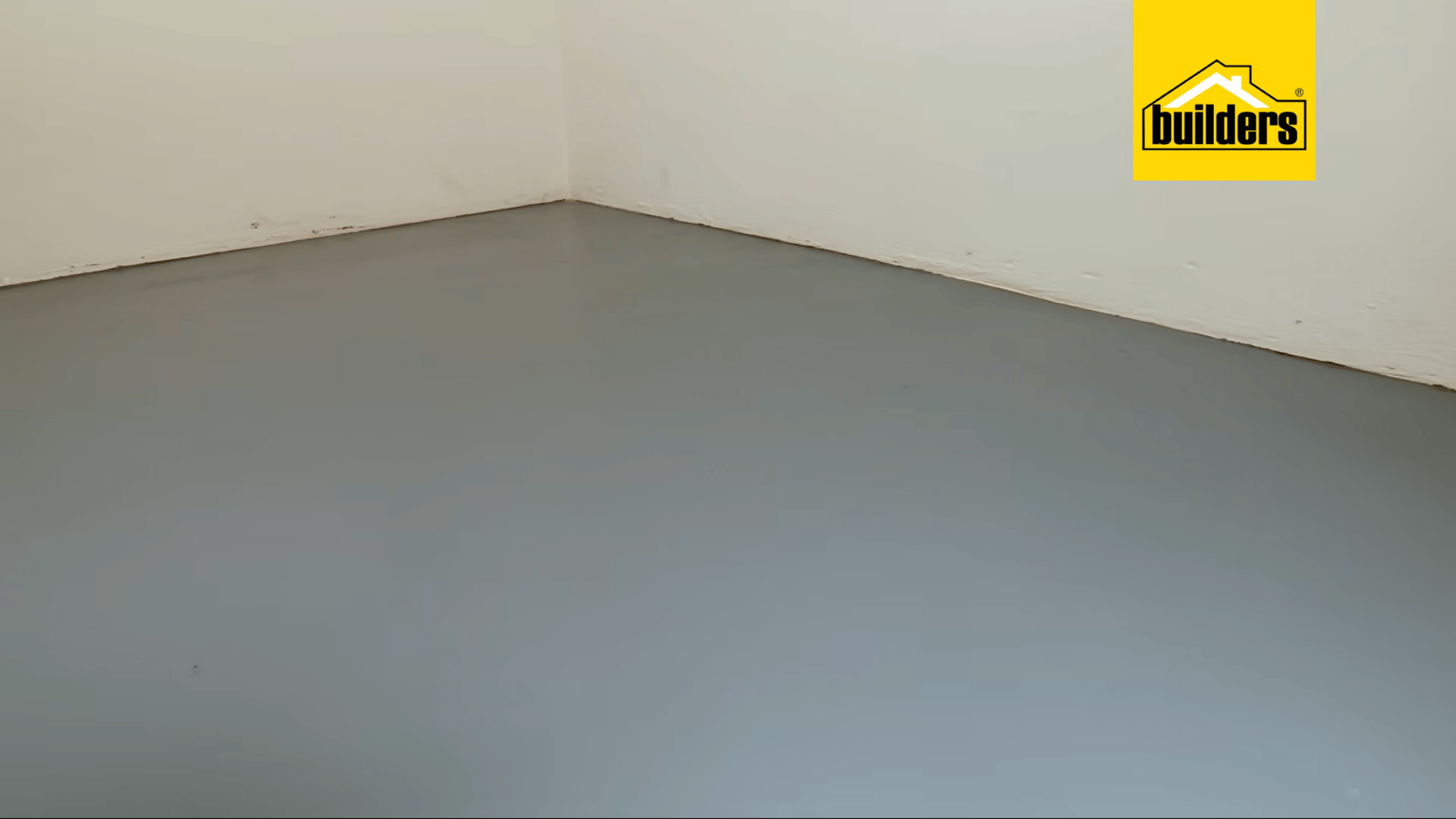 a freshly painted grey concrete floor with a smooth even finish ready for use after the final coat has fully dried