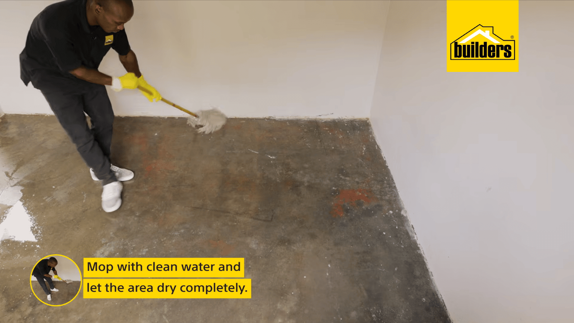 a person mops a cleaned concrete floor with clean water to remove residue before letting the surface dry completely
