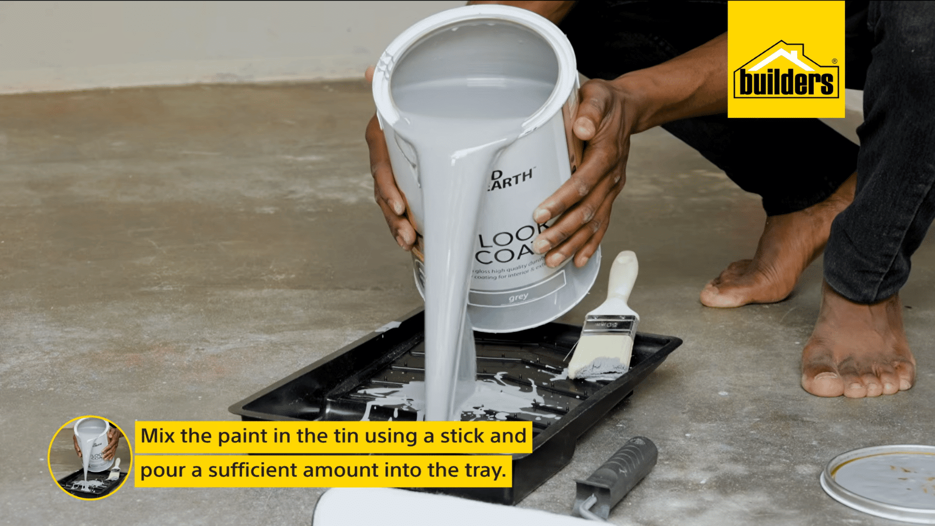 a person pours mixed grey floor paint into a paint tray after stirring it ready for applying an even coat to a concrete floor