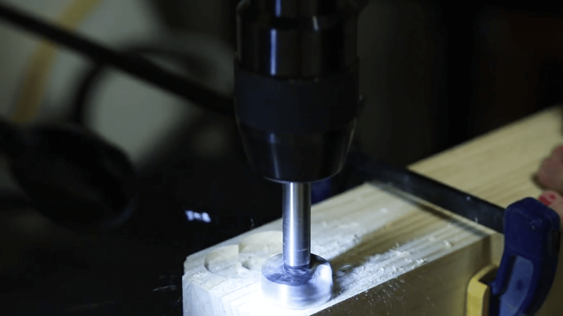 forstner bit creating shallow recesses around mounting holes for concealed plates and screws