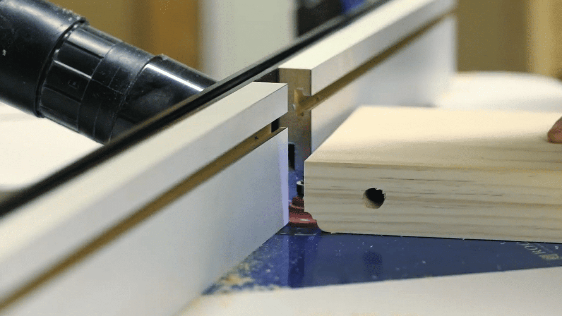 router shaping a decorative cove and bead profile along the visible edge of a pine shelf
