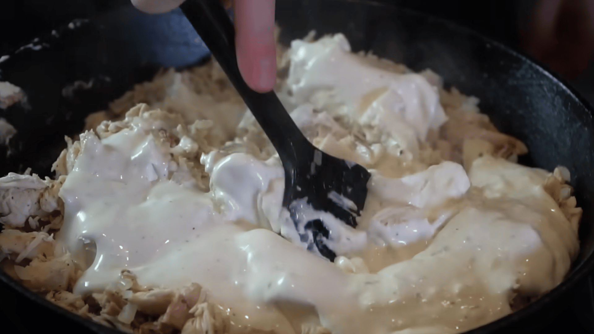 adding cream cheese and dressing mixture to buffalo chicken dip