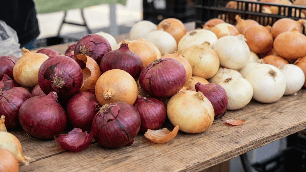 are onions keto varieties including red yellow white and sweet onions displayed fresh at a local market stand