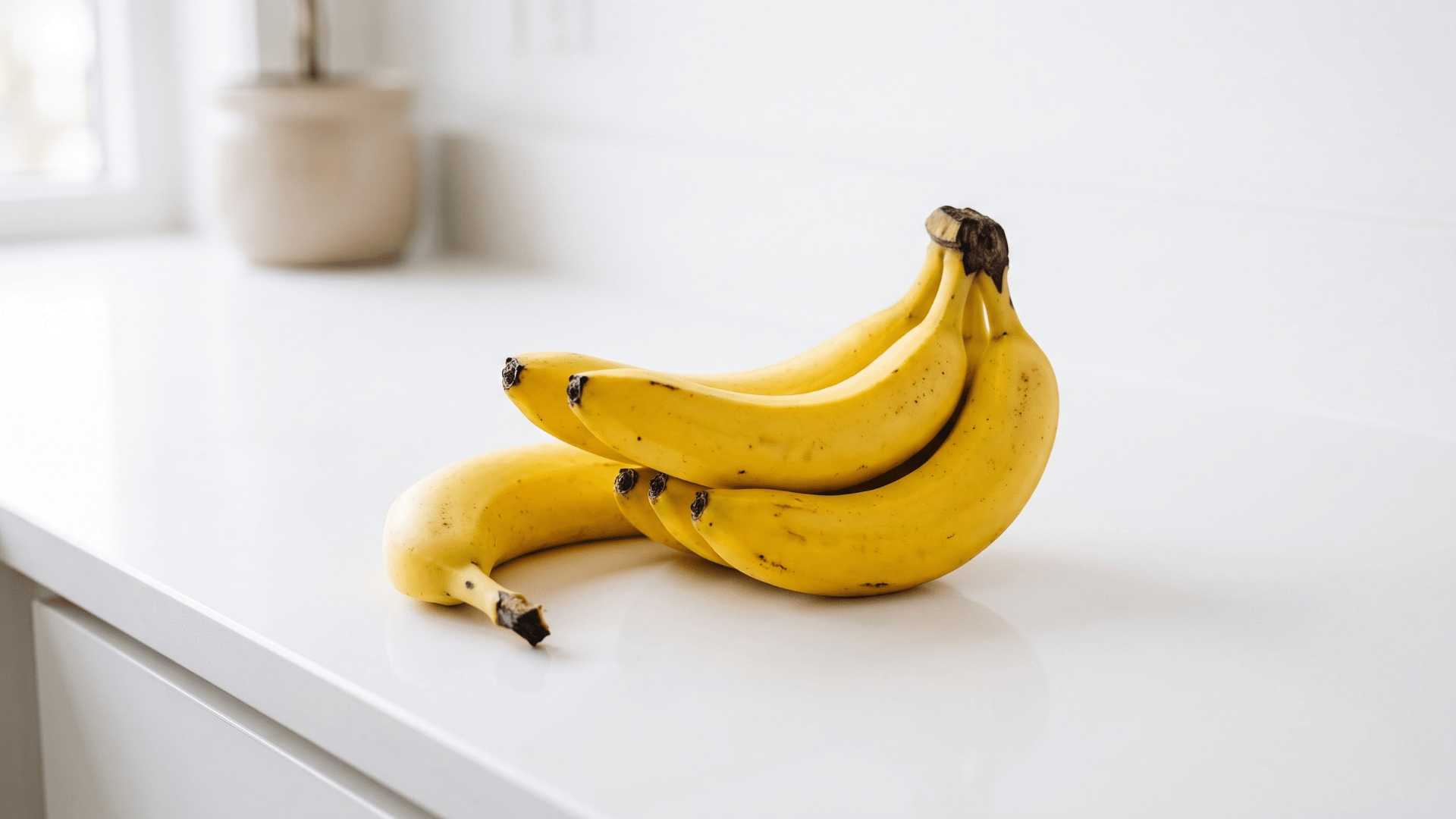 ripe bananas arranged on a kitchen counter as a healthy food that can be too high in carbs for keto