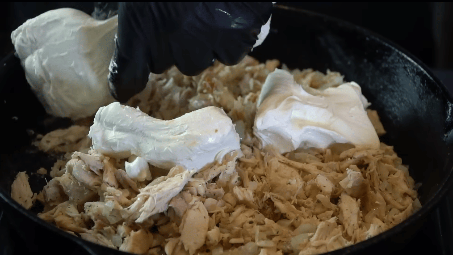 cooking chopped onion and chicken with ranch seasoning in a skillet