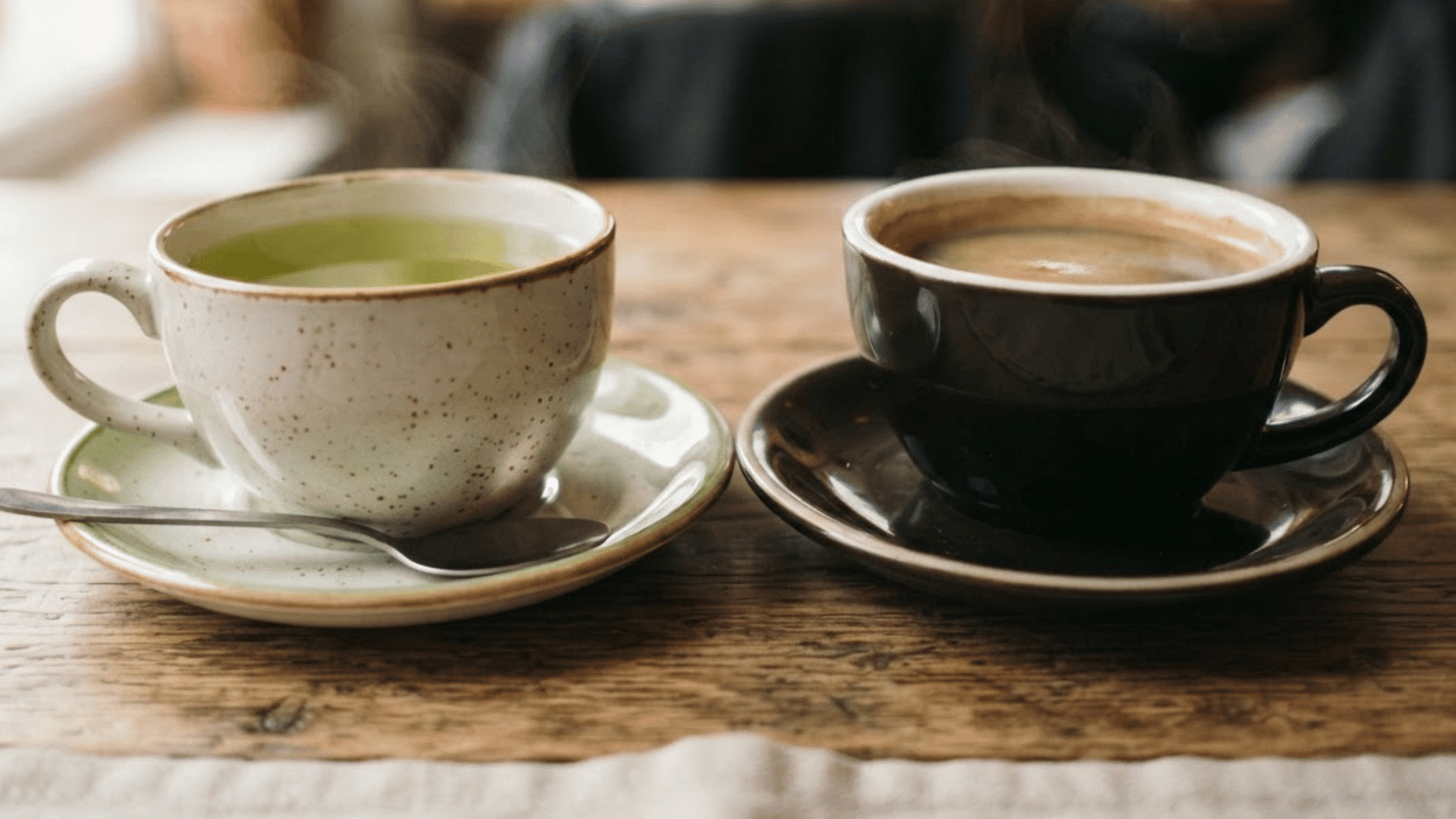 green tea and coffee cups side by side showing does green tea have more caffeine than coffee