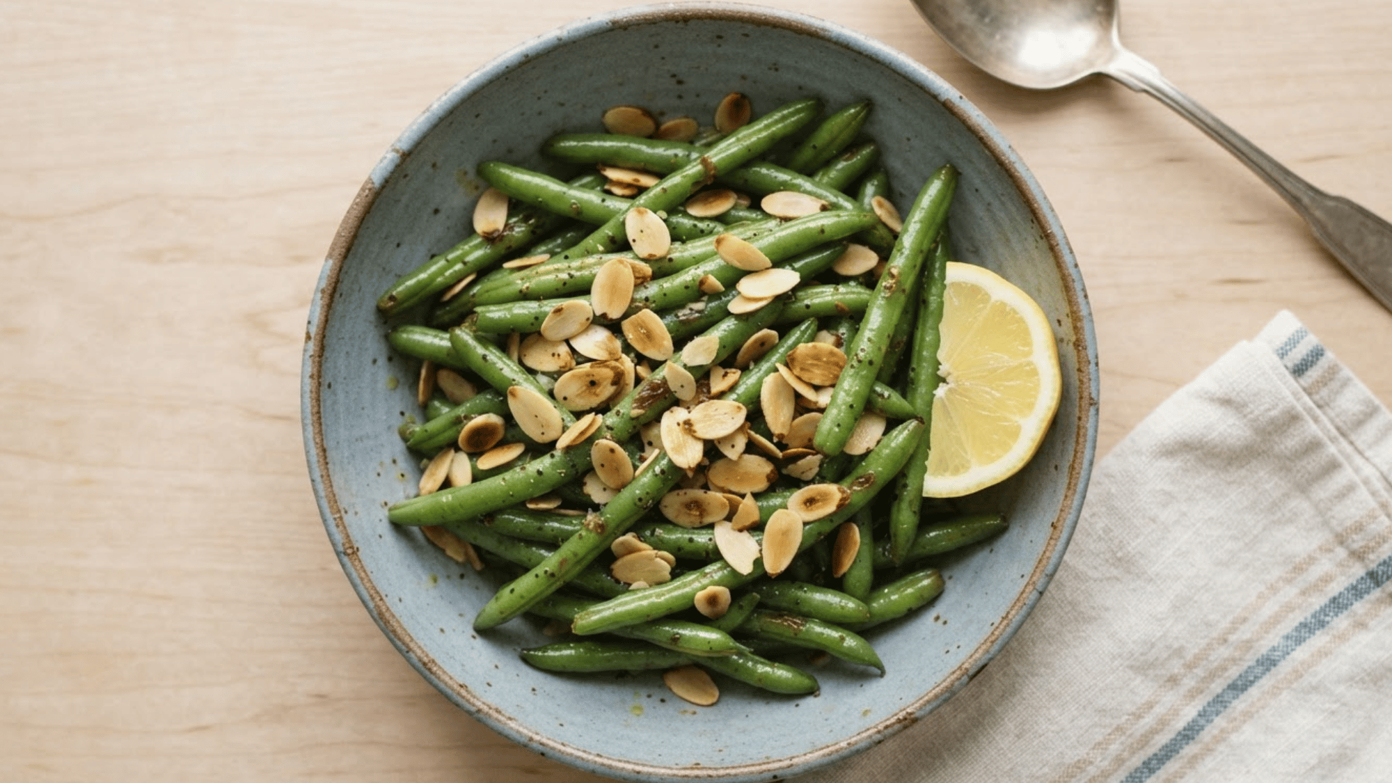 green beans with toasted almonds and herbs served in a dish for a simple crunchy savory side dish