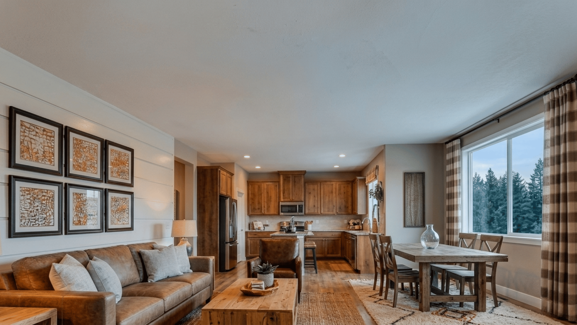 open concept living room with brown sofa wooden table dining area and warm kitchen beside large windows