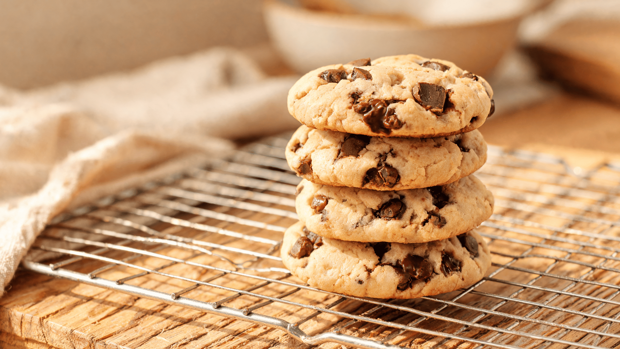 paleo chocolate chip cookies with crisp edges and soft centers topped with melted chocolate chips on a plate