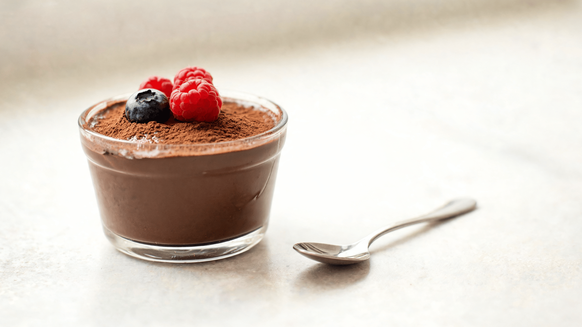 paleo chocolate pudding with a smooth creamy texture served in a small bowl as a rich chocolate dessert