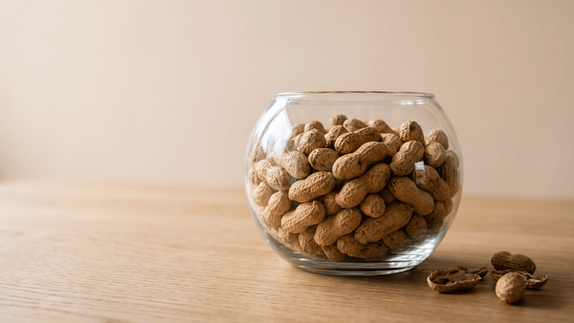plain roasted peanuts in a small bowl as a lower carb legume snack for a keto style eating plan