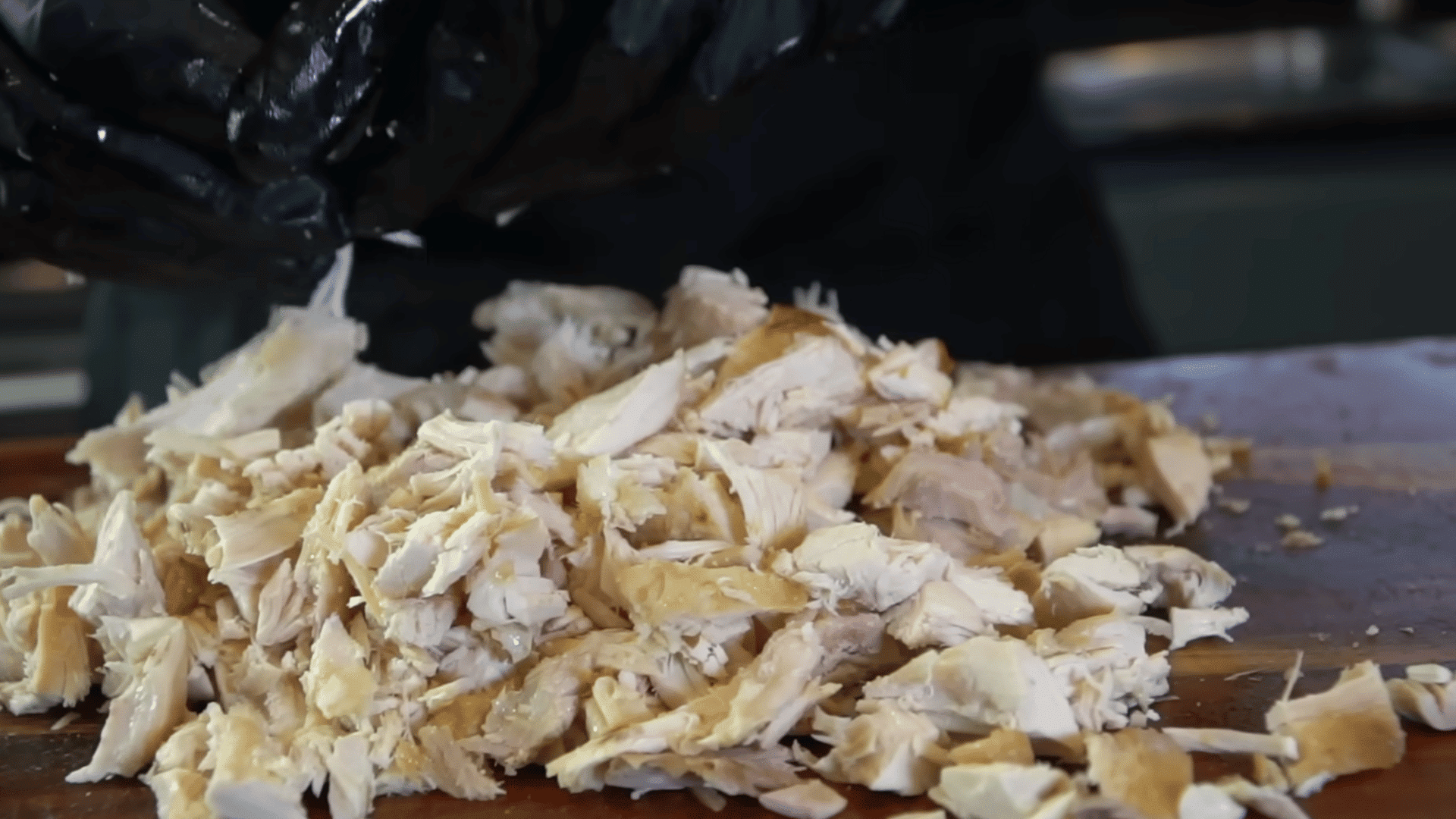 preparing yellow onion and rotisserie chicken for buffalo chicken dip